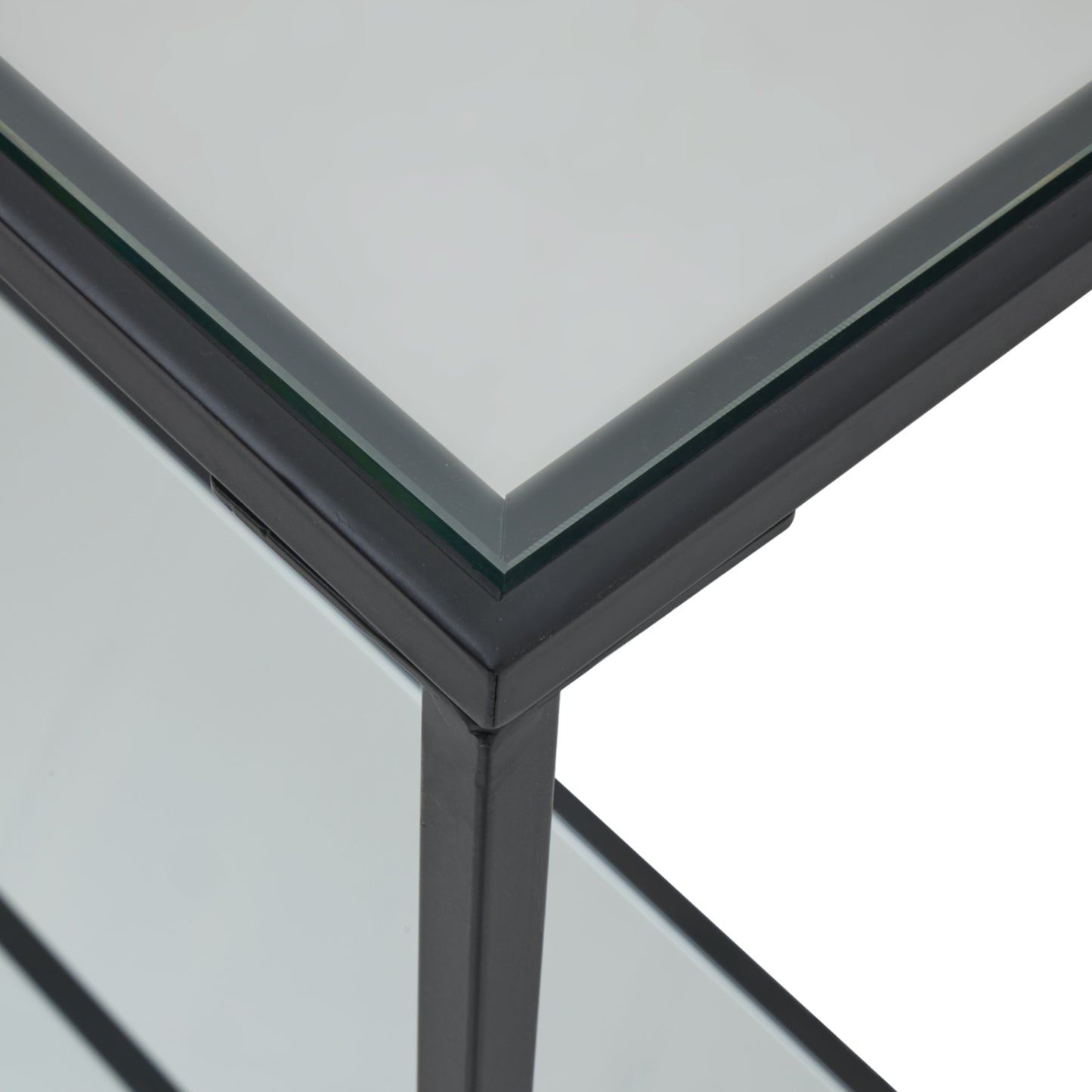 corner of black framed console table with mirrored table top glass