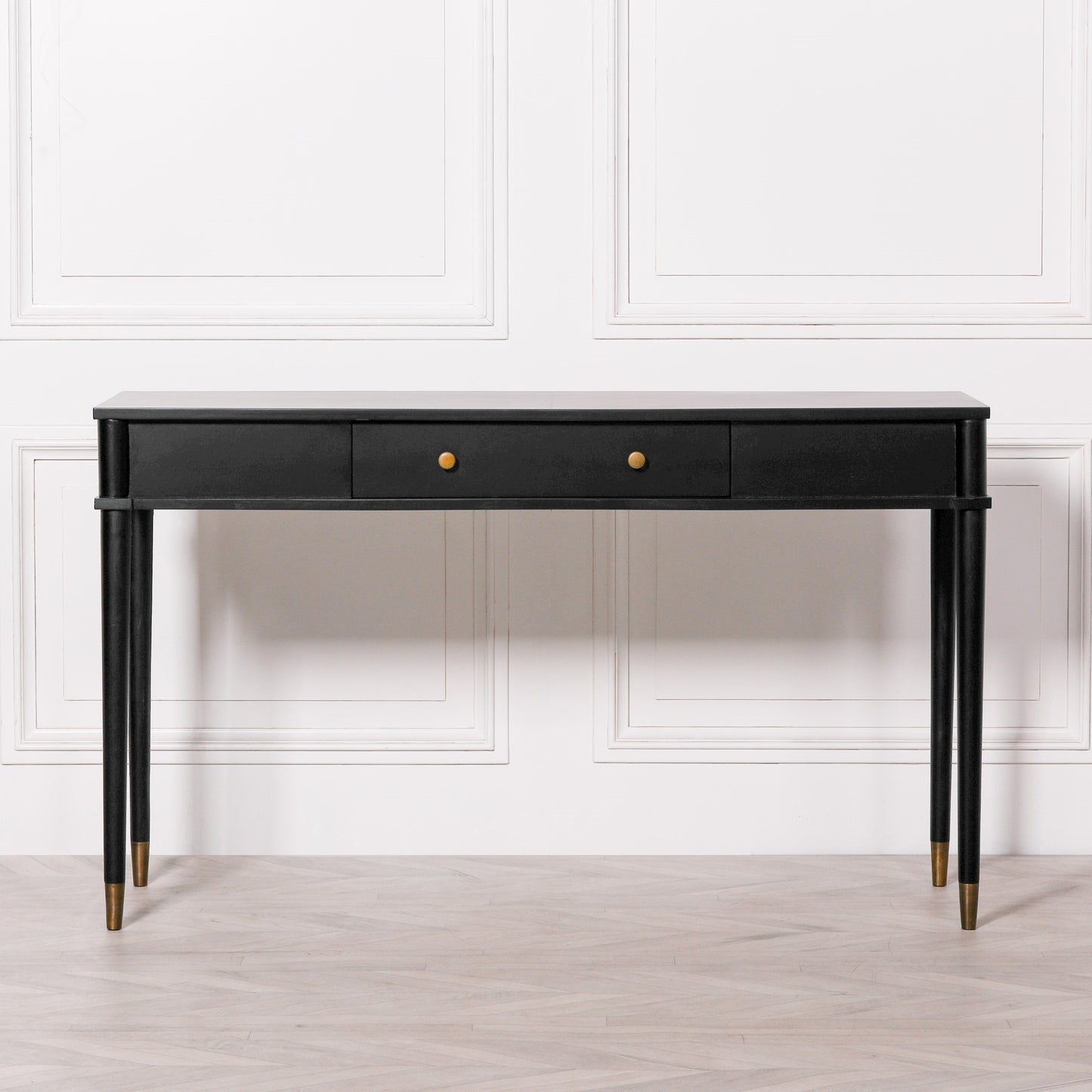 This NOIR CONSOLE is expertly constructed with hand-crafted white cedar and finished in a sleek black paint with brass detailing