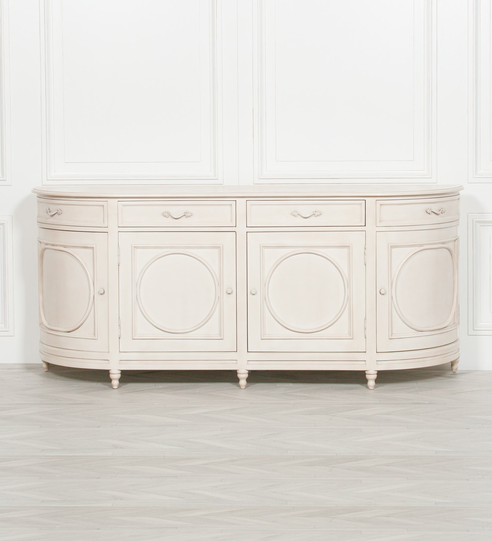 IVORY AGED SIDEBOARD aged ivory finish paired with ornate detailing across the door panels and handles