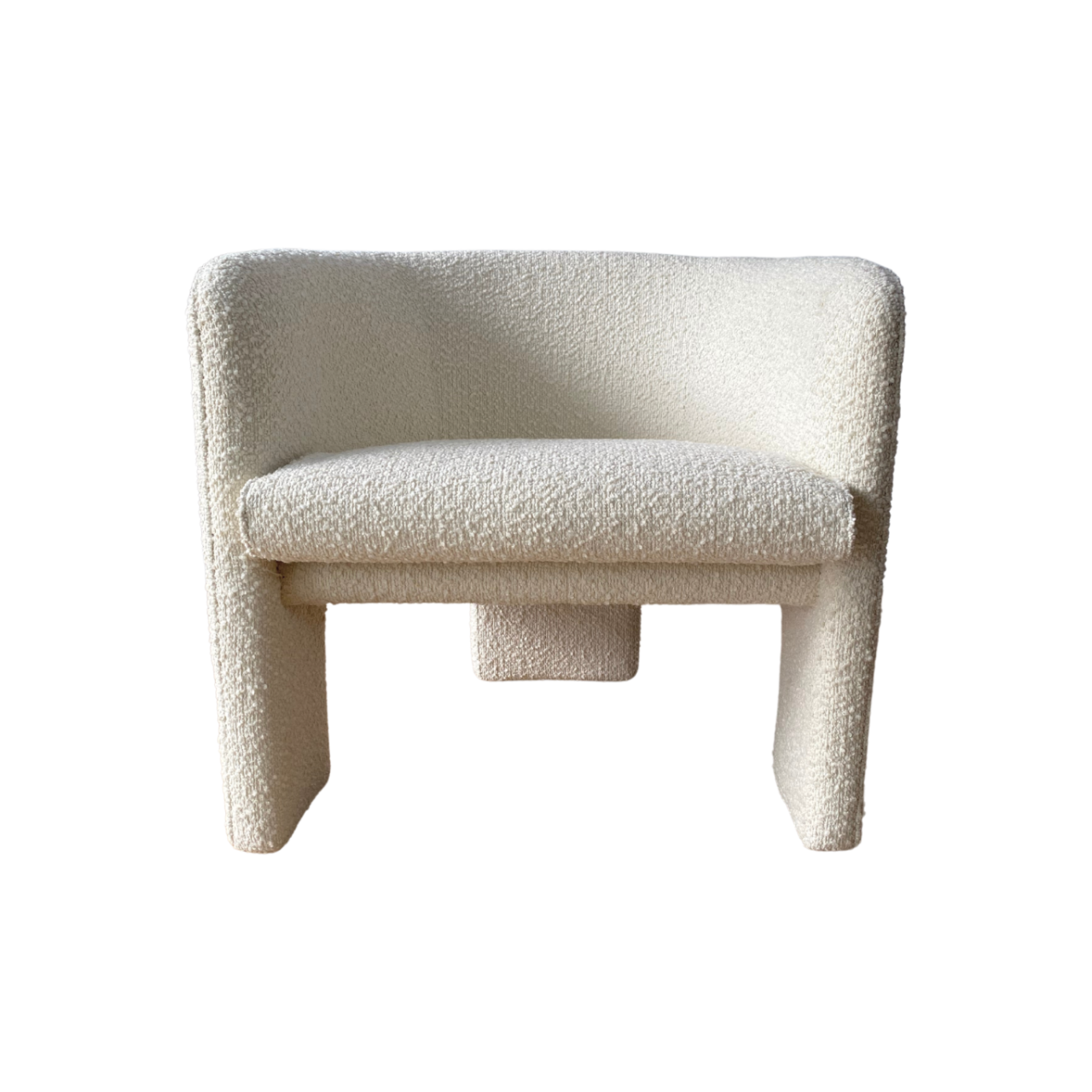 the phoebe armchair features a curved design and soft boucle fabric upholstery