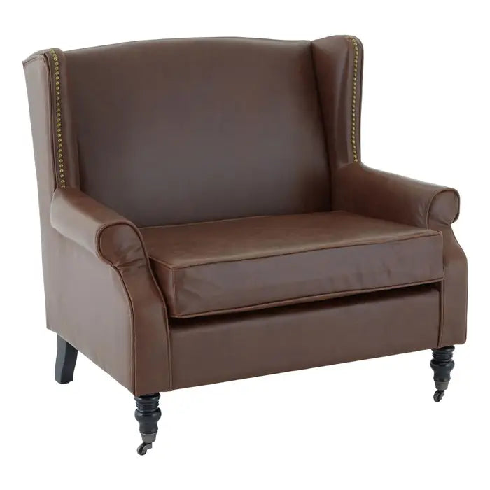 Brown faux leather wing chair with gold studs and carved legs 