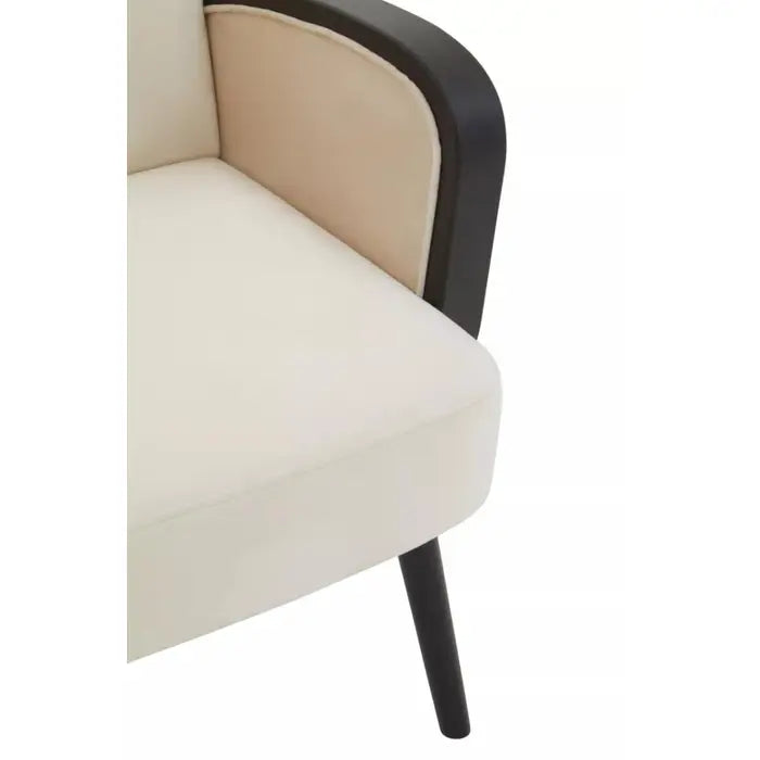 Close up if seat- Luxury neutral toned armchair featuring rattan detailed arm rest and curved backrest